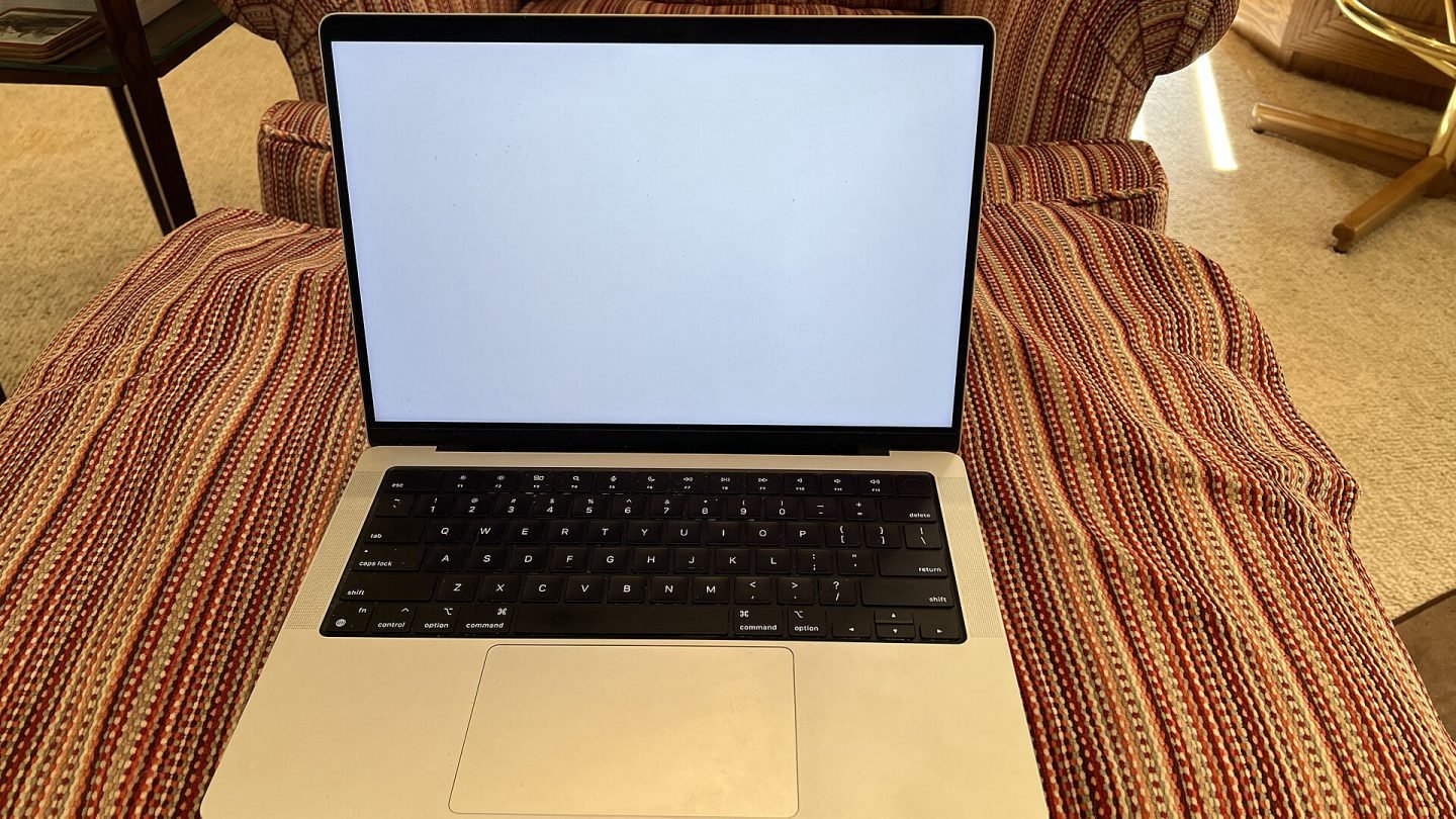 14-inch Apple MacBook Pro in silver on a sofa