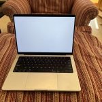 14-inch Apple MacBook Pro in silver on a sofa