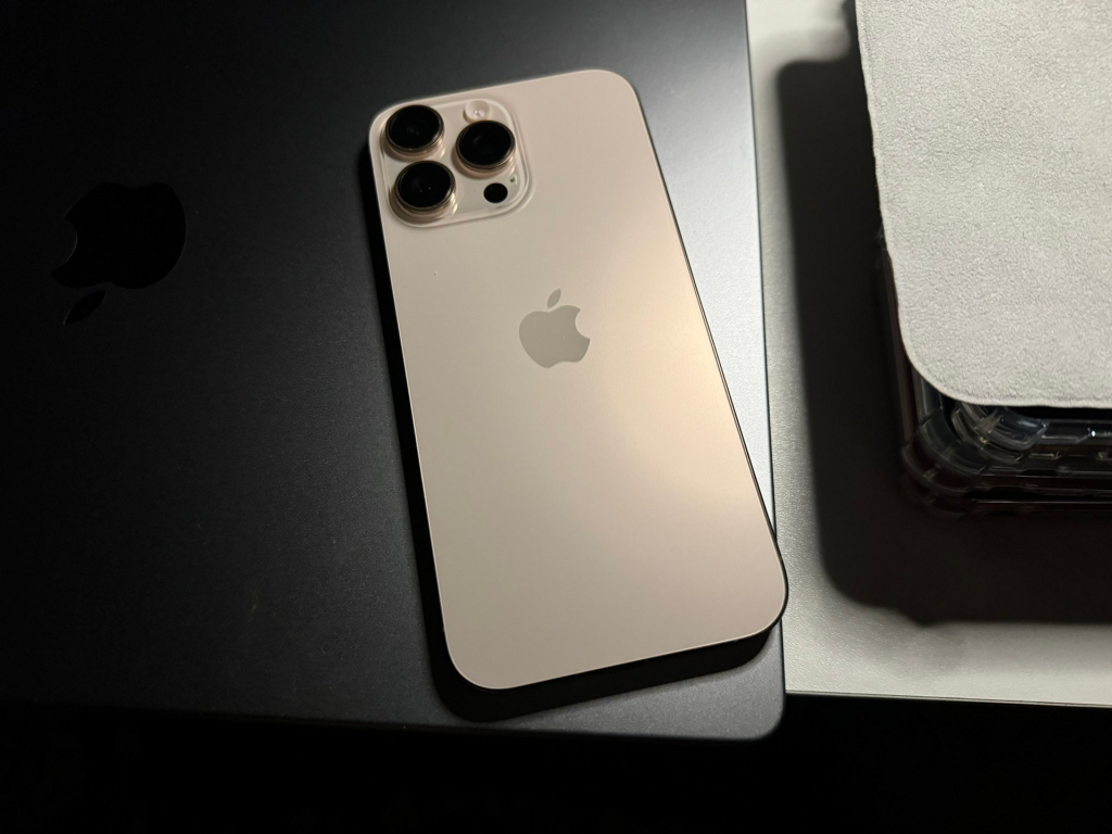 Apple iPhone 16 Pro Max in Desert Titanium, rear view