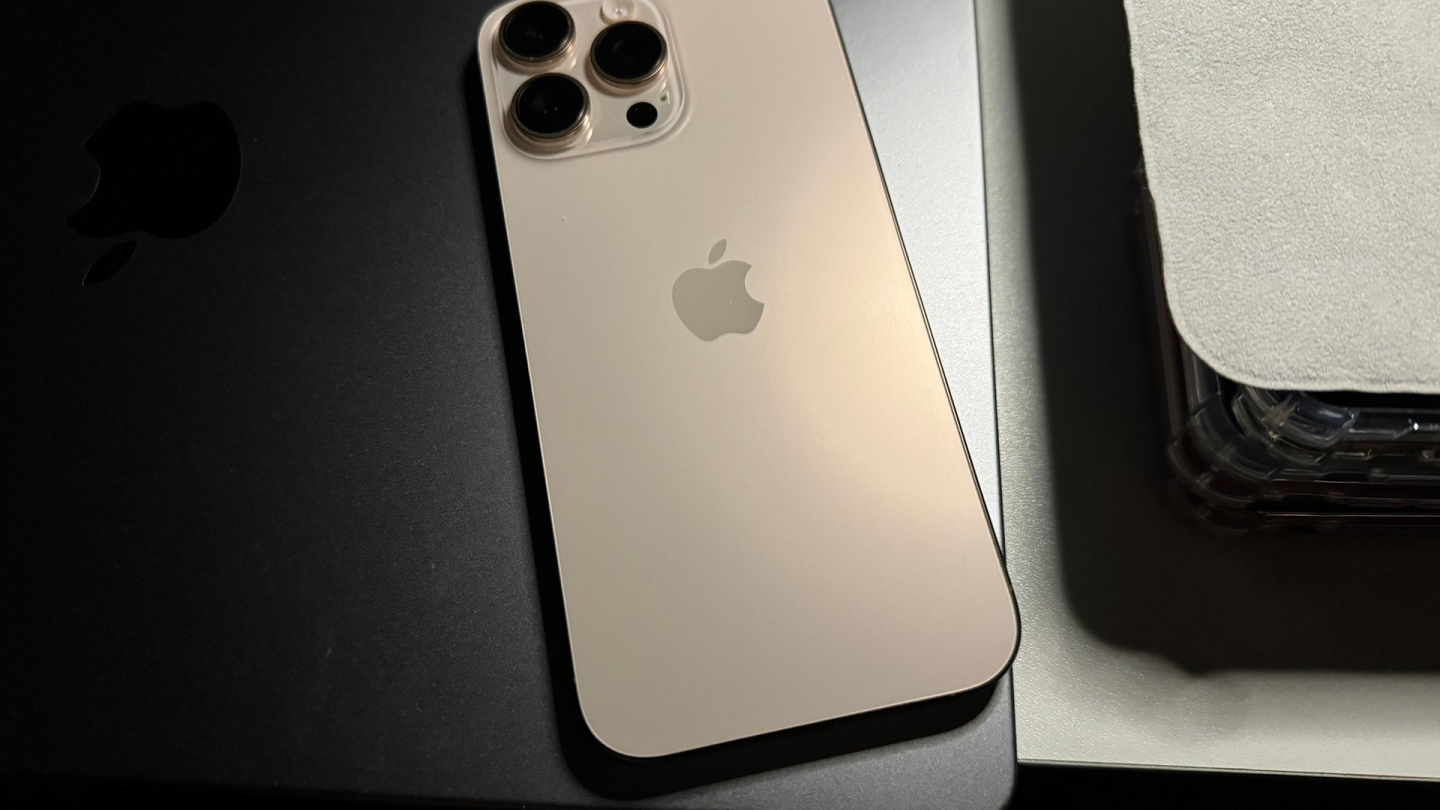 Apple iPhone 16 Pro Max in Desert Titanium, rear view
