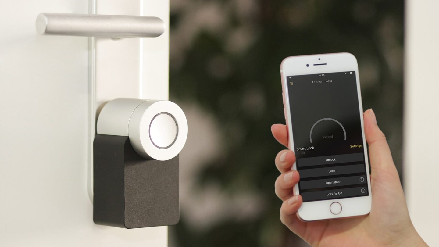 Nuki smart lock on a door with a phone app