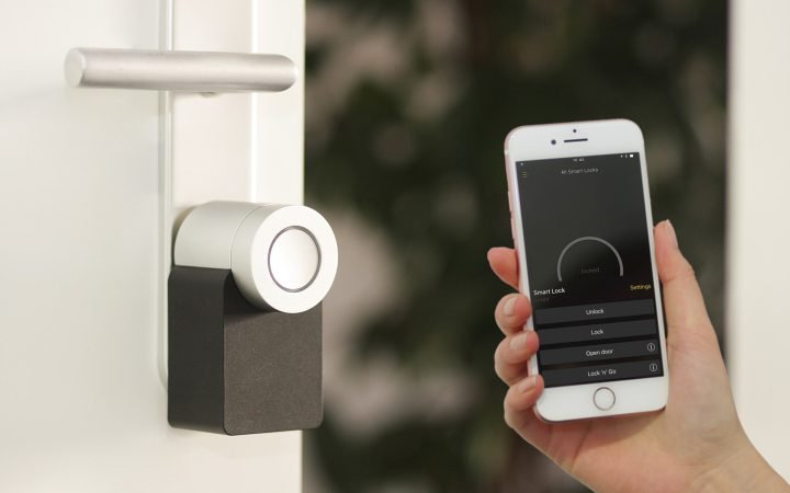 Nuki smart lock on a door with a phone app