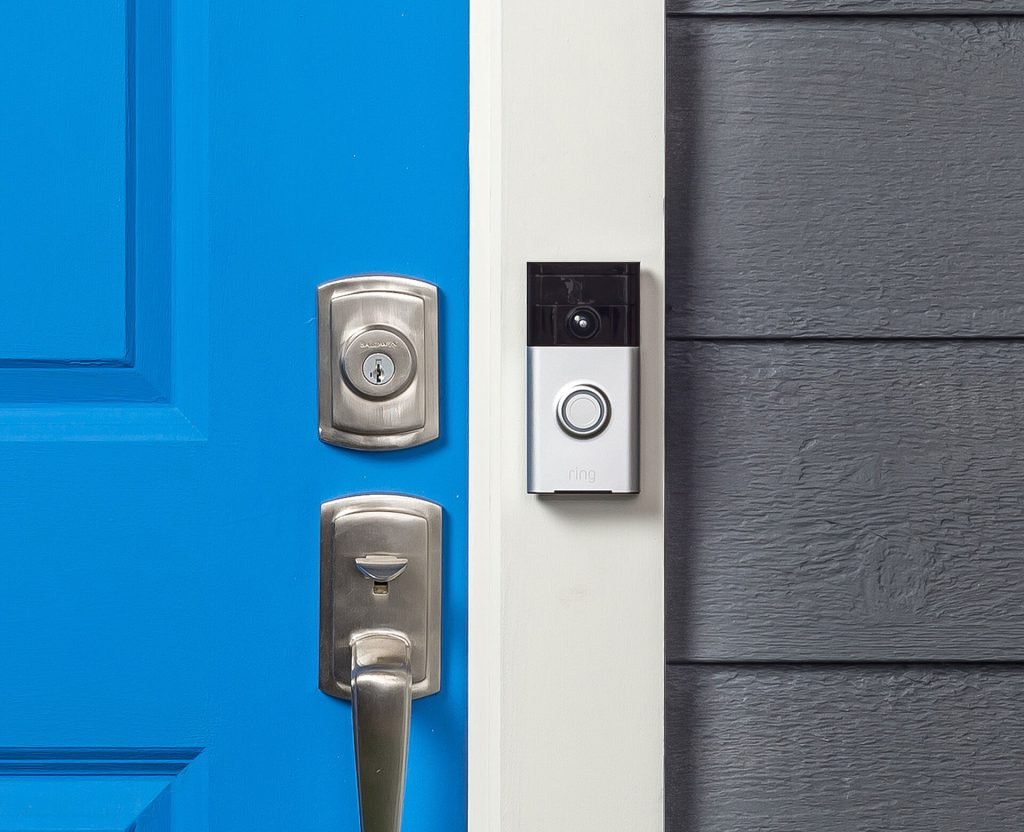 Ring video doorbell beside a blue front door
